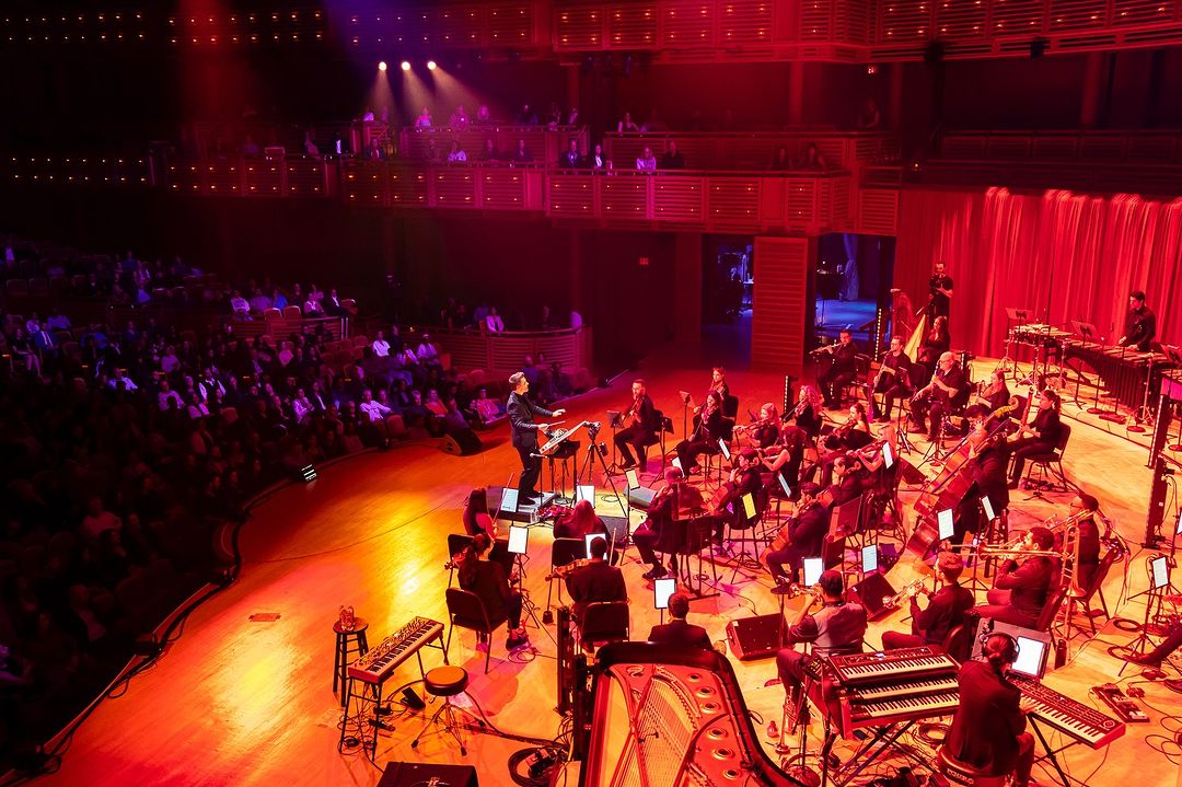 Nu Deco Ensemble performing at the Adrienne Arsht Center in red stage lighting