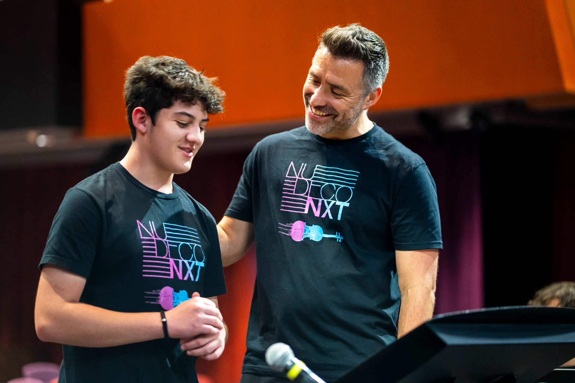 Nu Deco NXT mentor sharing a moment with a young musician backstage
