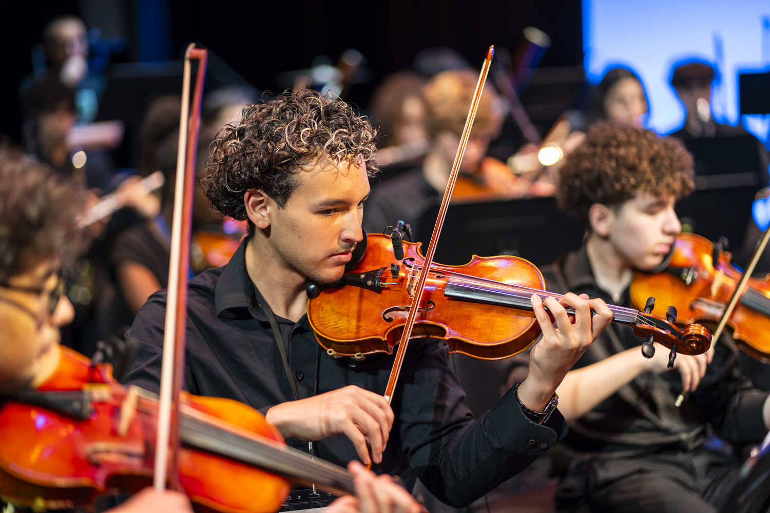 NXT violinist Moises Barroeta performing with the Writers Cohort 2026