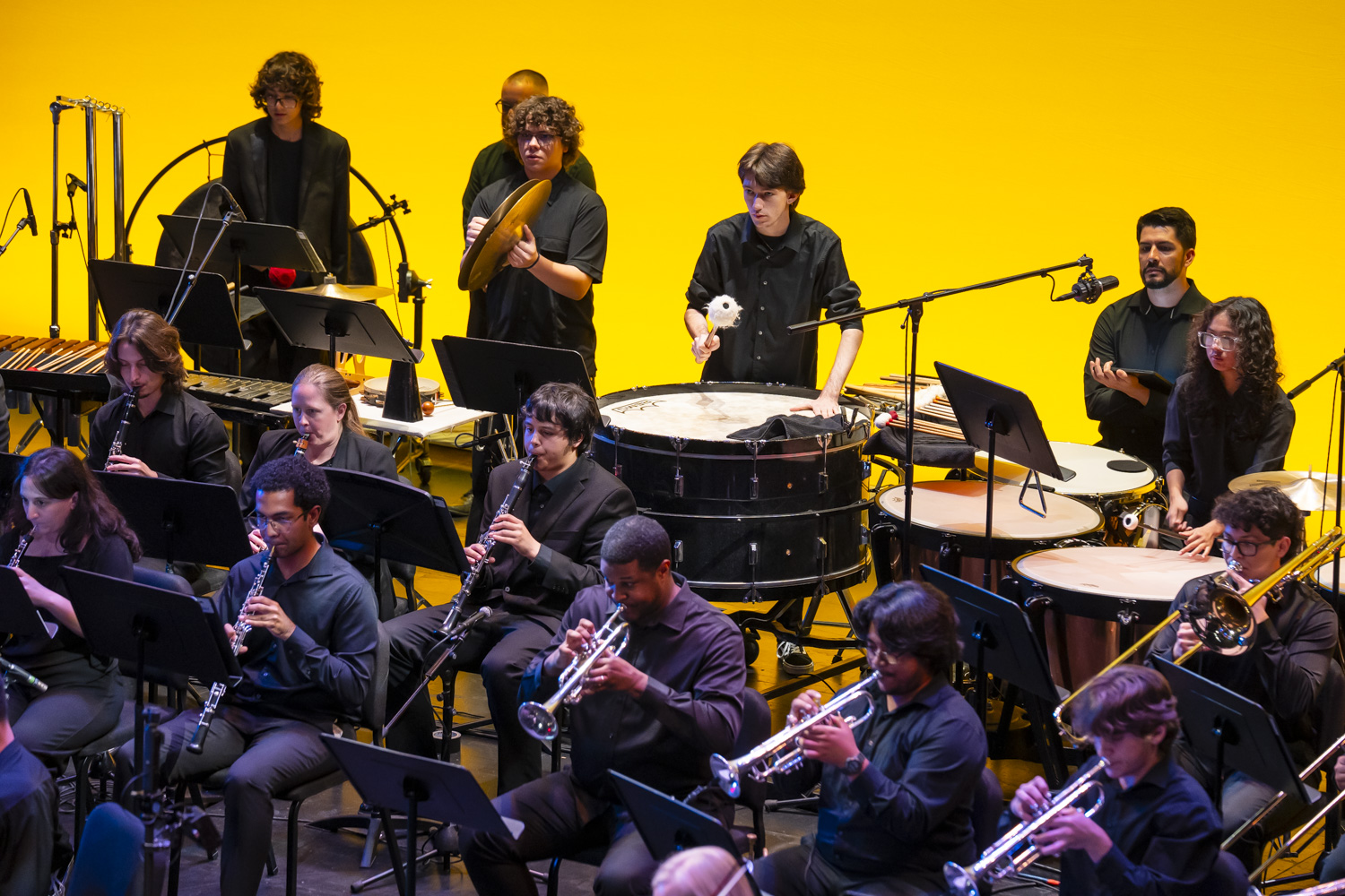 NXT brass and percussion sections performing on stage in 2026