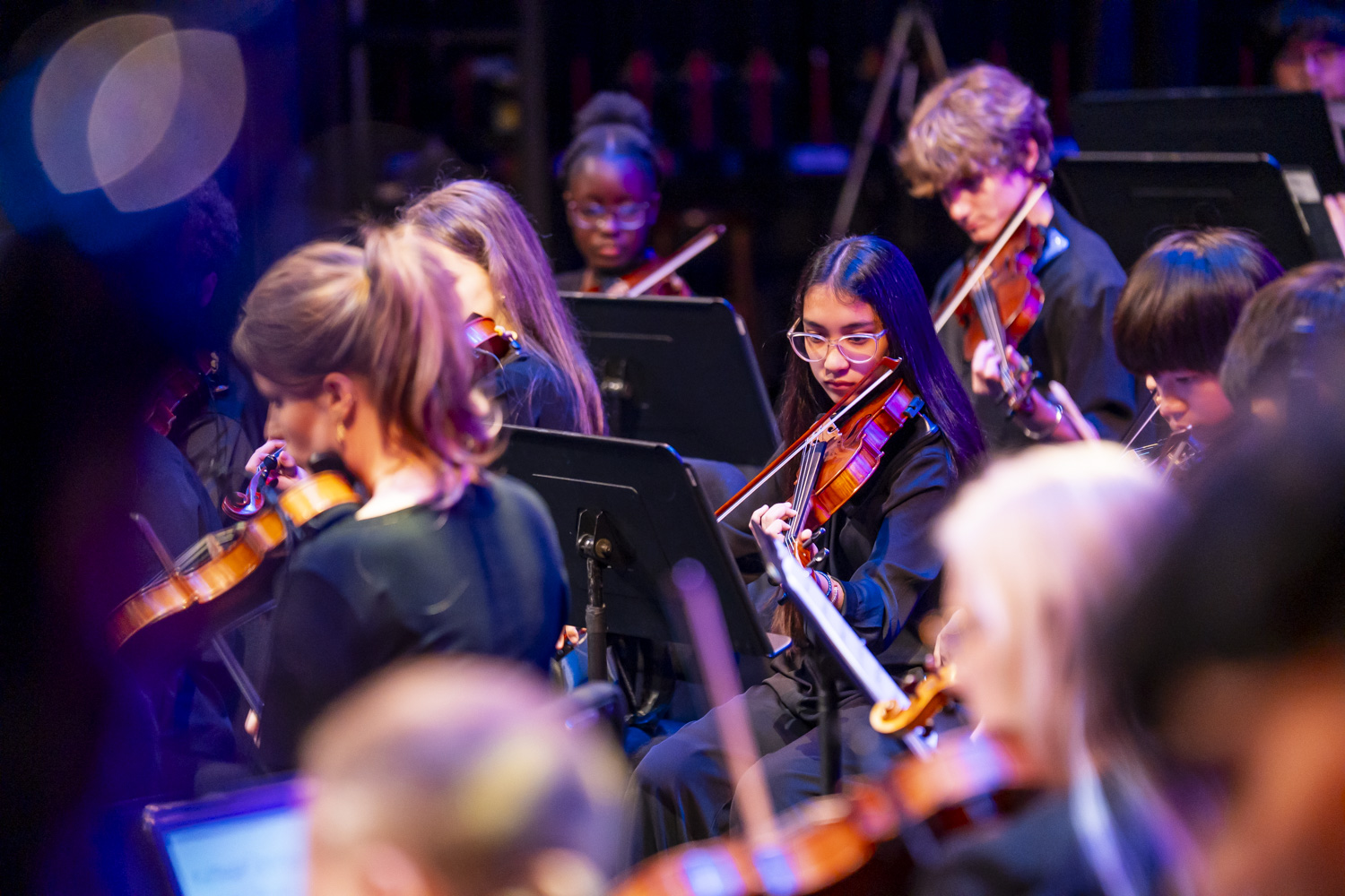NXT violin section performing on stage
