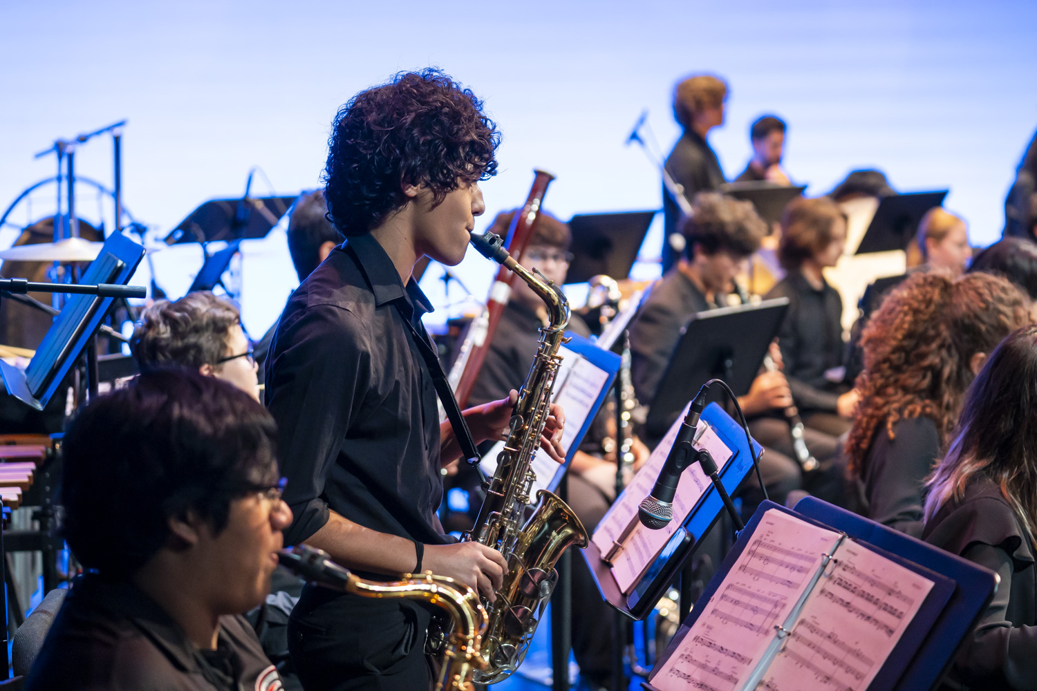 NXT alto saxophonist Rodrigo Arrivillaga performing on stage