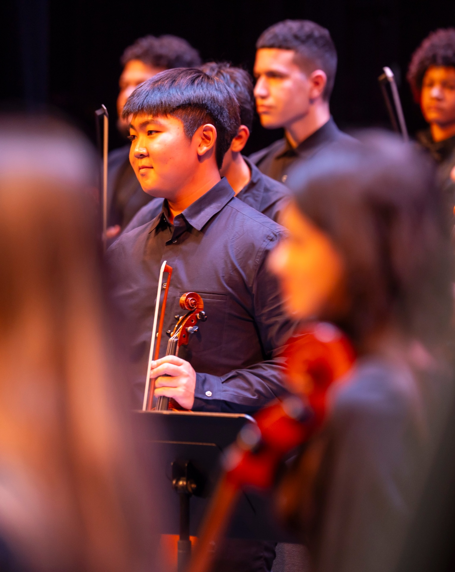 NXT violinist Jaden Lee on stage holding his violin