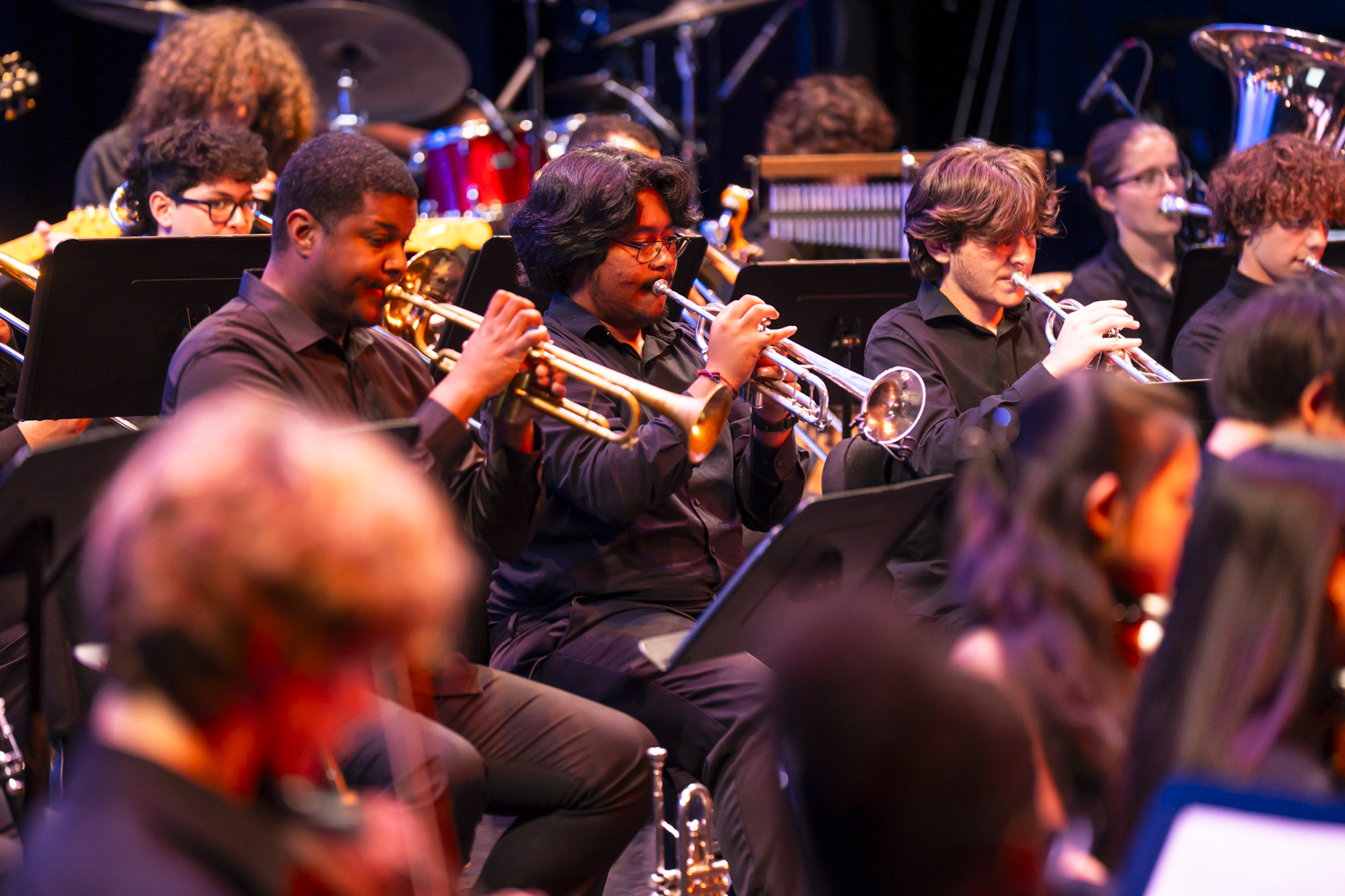 NXT brass section performing on stage in 2026