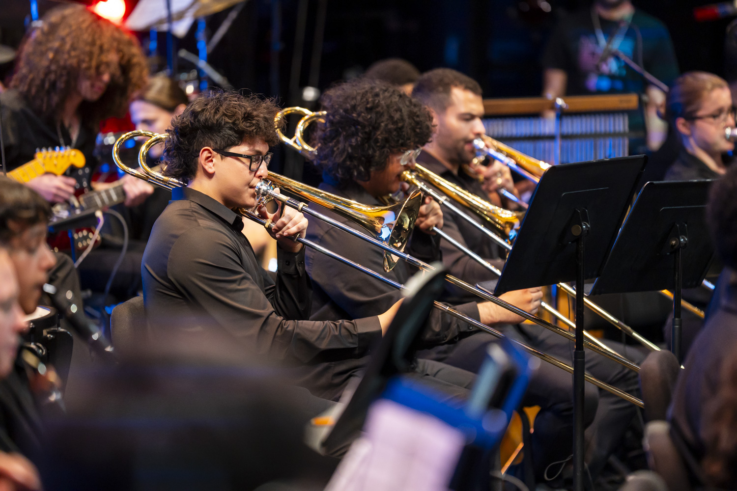 NXT trombone section performing on stage in 2026